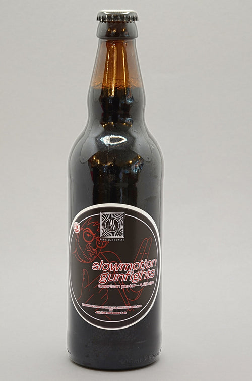 A dark brown glass bottle of All Day Brewing beer with a black cap and a black label featuring red and white text, set against a plain light gray background.