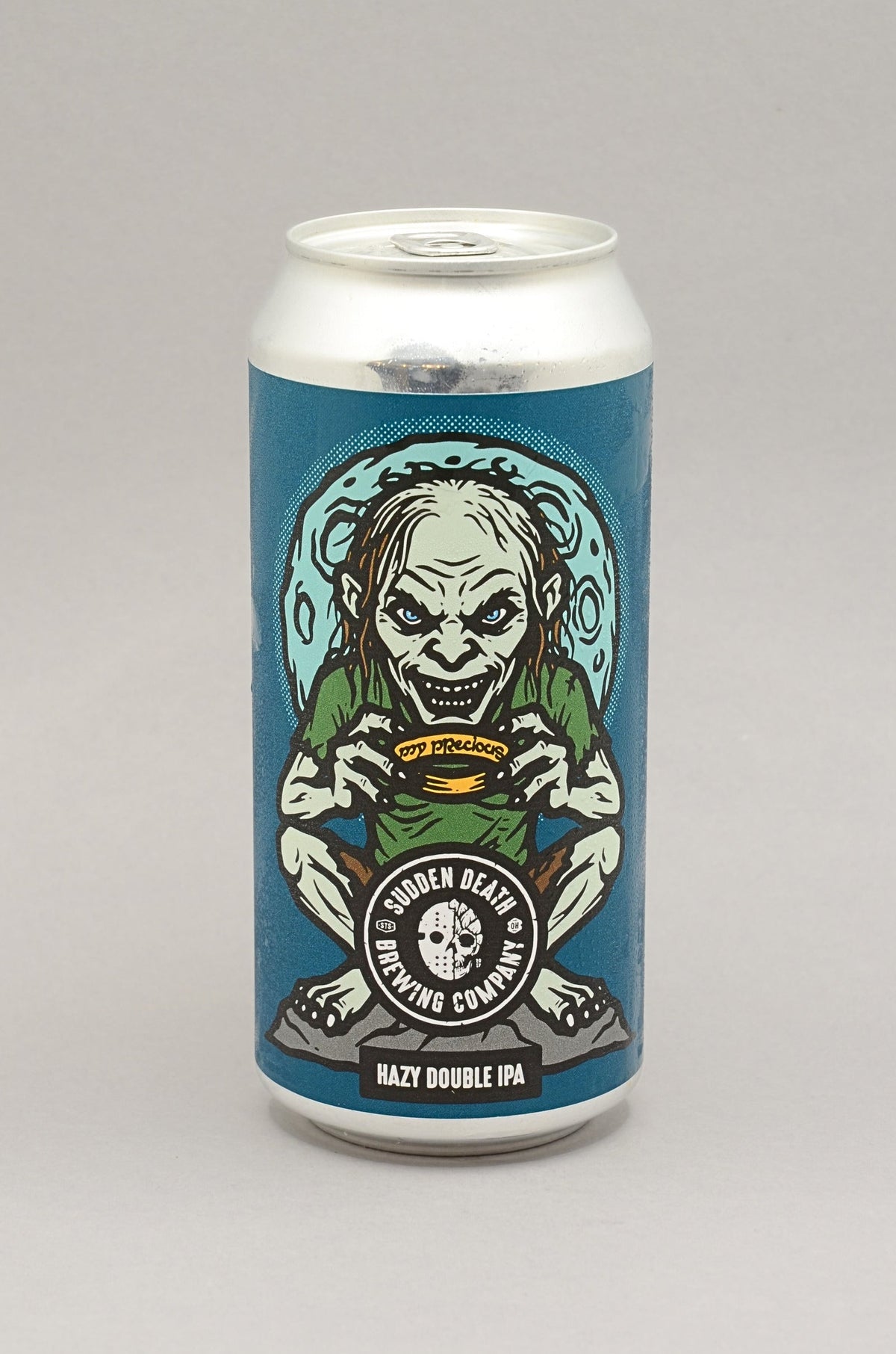 A 12 oz aluminum can of Ghoulish Hops Goulash Double IPA by Ghoulish Hops Brewing Company, featuring a graphic illustration of a zombie holding a bowl of soup on a blue label, set against a neutral gray background.