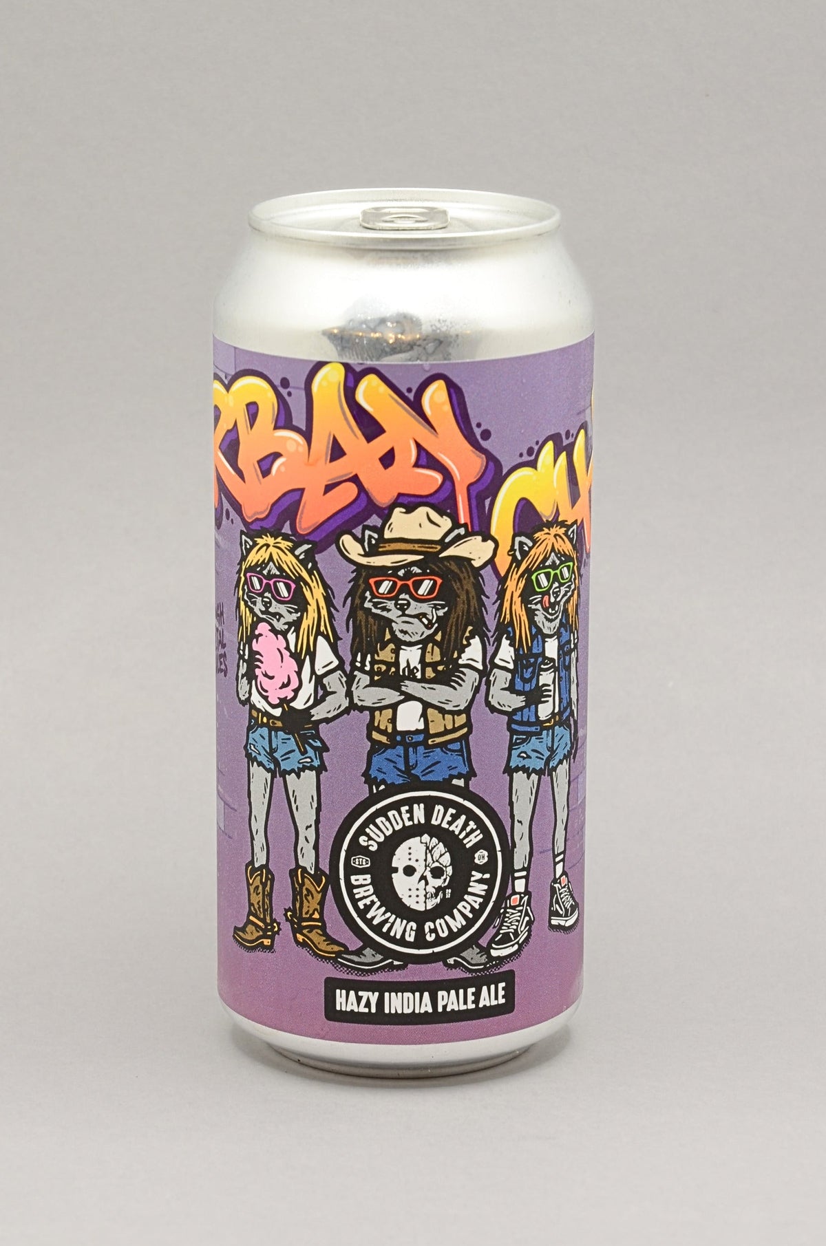 A 440ml aluminium can of Sudden Death Brewing Co. Hazy India Pale Ale, featuring a purple label with cartoon characters and graffiti-style lettering, set against a neutral gray background.