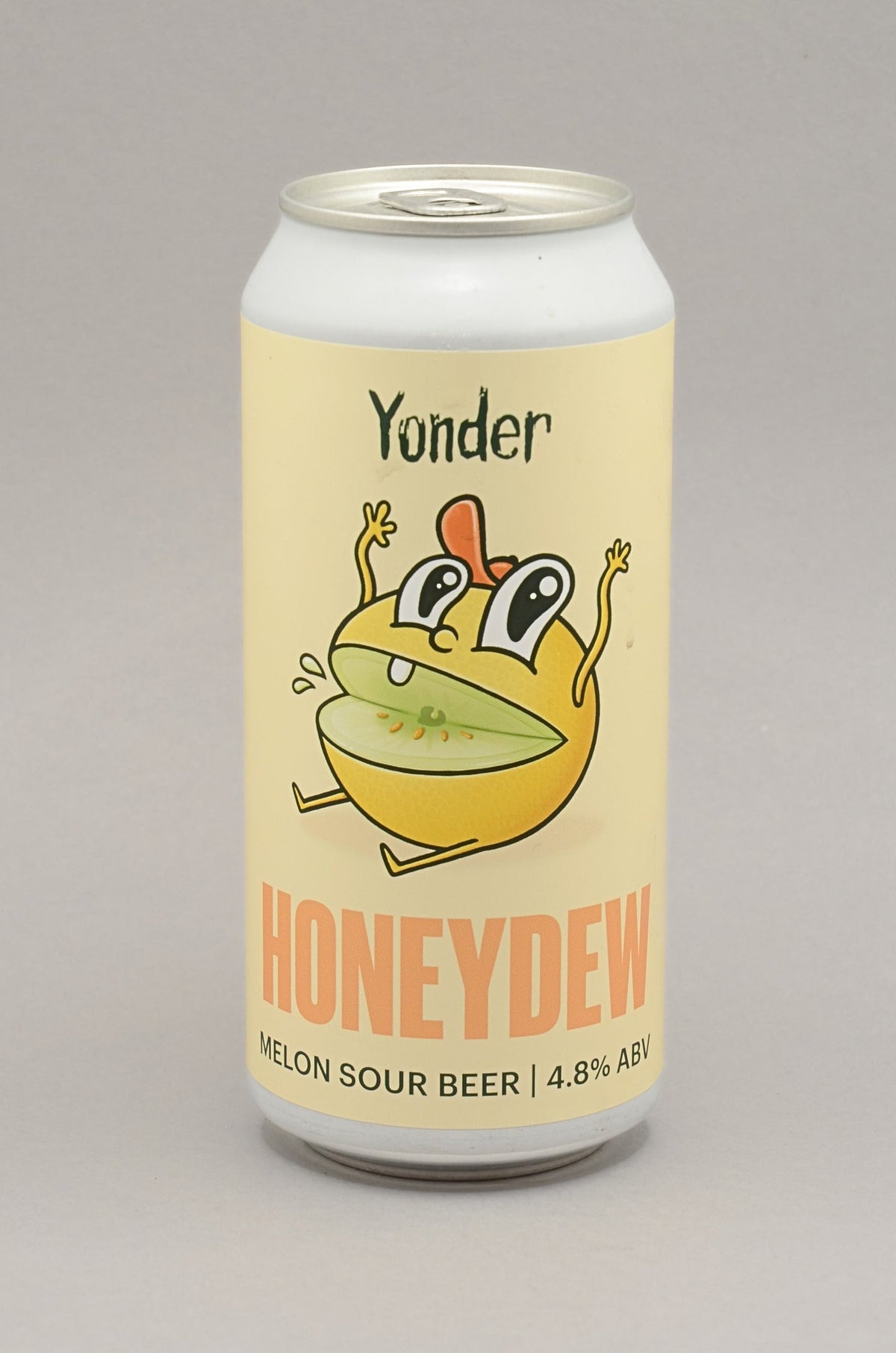 A can of Yonder Honeydew melon Sour Beer on a neutral gray background. The can features a pale yellow label with a cartoon illustration of a green and yellow melon character wearing an orange hat, and the word 'HONEYDEW' in orange text.